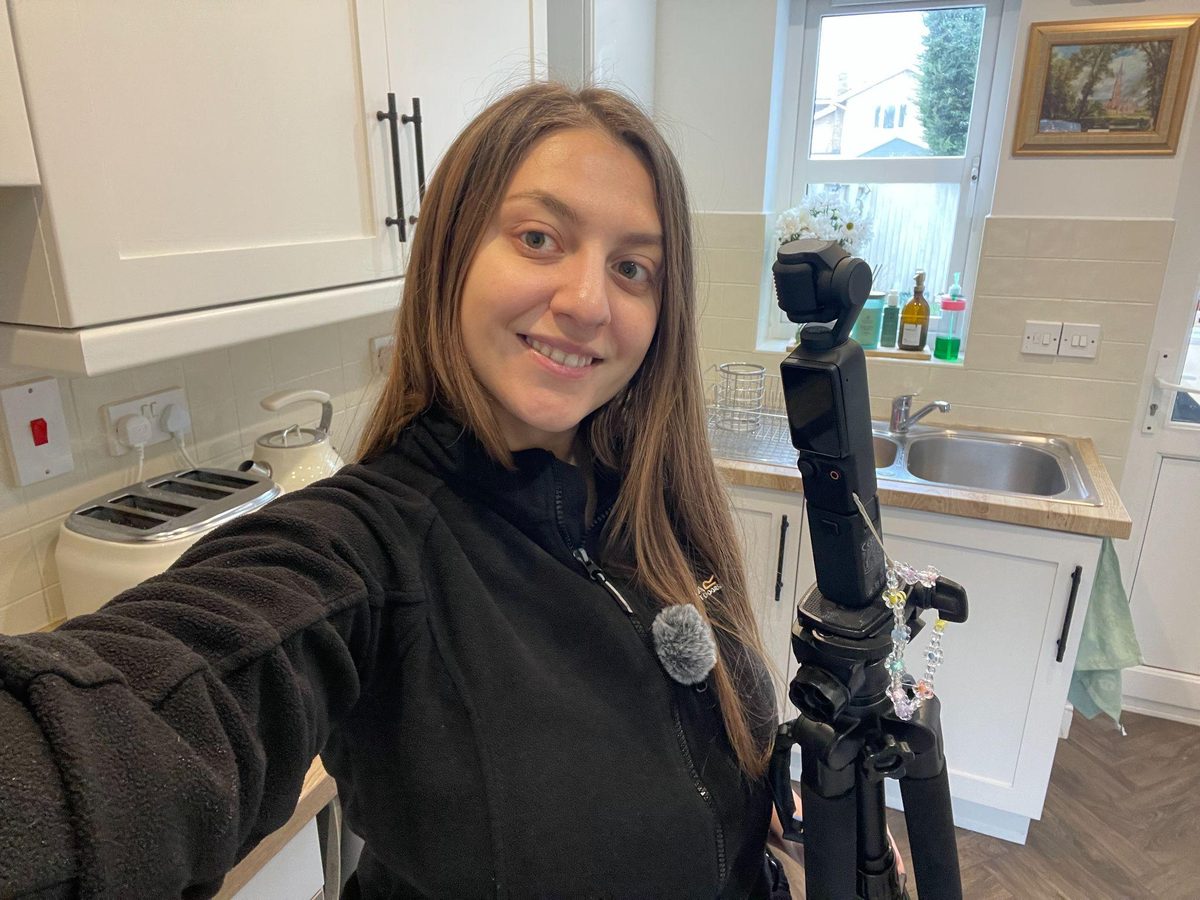 Izabela filming content at home with a gimbal